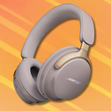 Bose QuietComfort Ultra headphones on orange abstract background