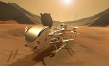 An artist's conception of the Dragonfly spacecraft settled down on the surface of Saturn's moon Titan.