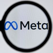 meta logo seen through a magnifying glass