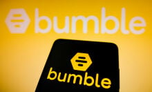 Bumble logo seen displayed on a smartphone and in the background.