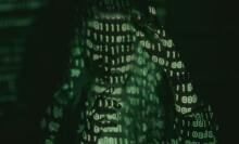 shadowy person with green binary code on body