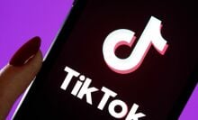 In this photo illustration, the TikTok logo is displayed on the screen of an iPhone.