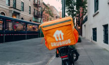 Grubhub bag on delivery bike with restaurant in peripherals