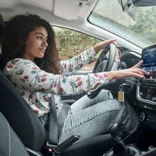 woman touching car smart display