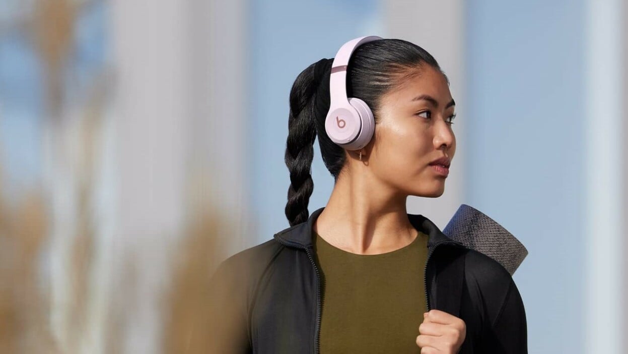 A woman wears a pair of Beats Solo 4