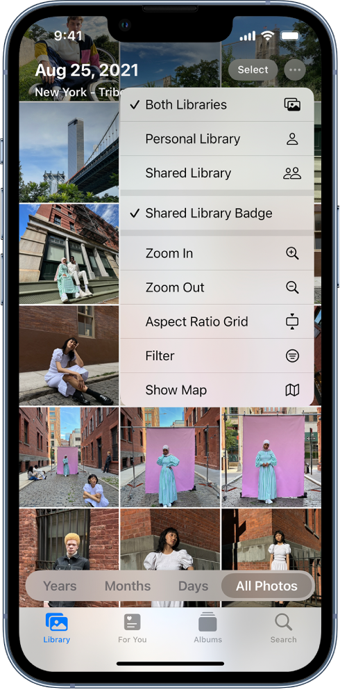 The Photos app showing a photo library in the Photos app. The More button at the top of the screen is selected, showing Both Libraries and Shared Library Badge selected with checkmarks.