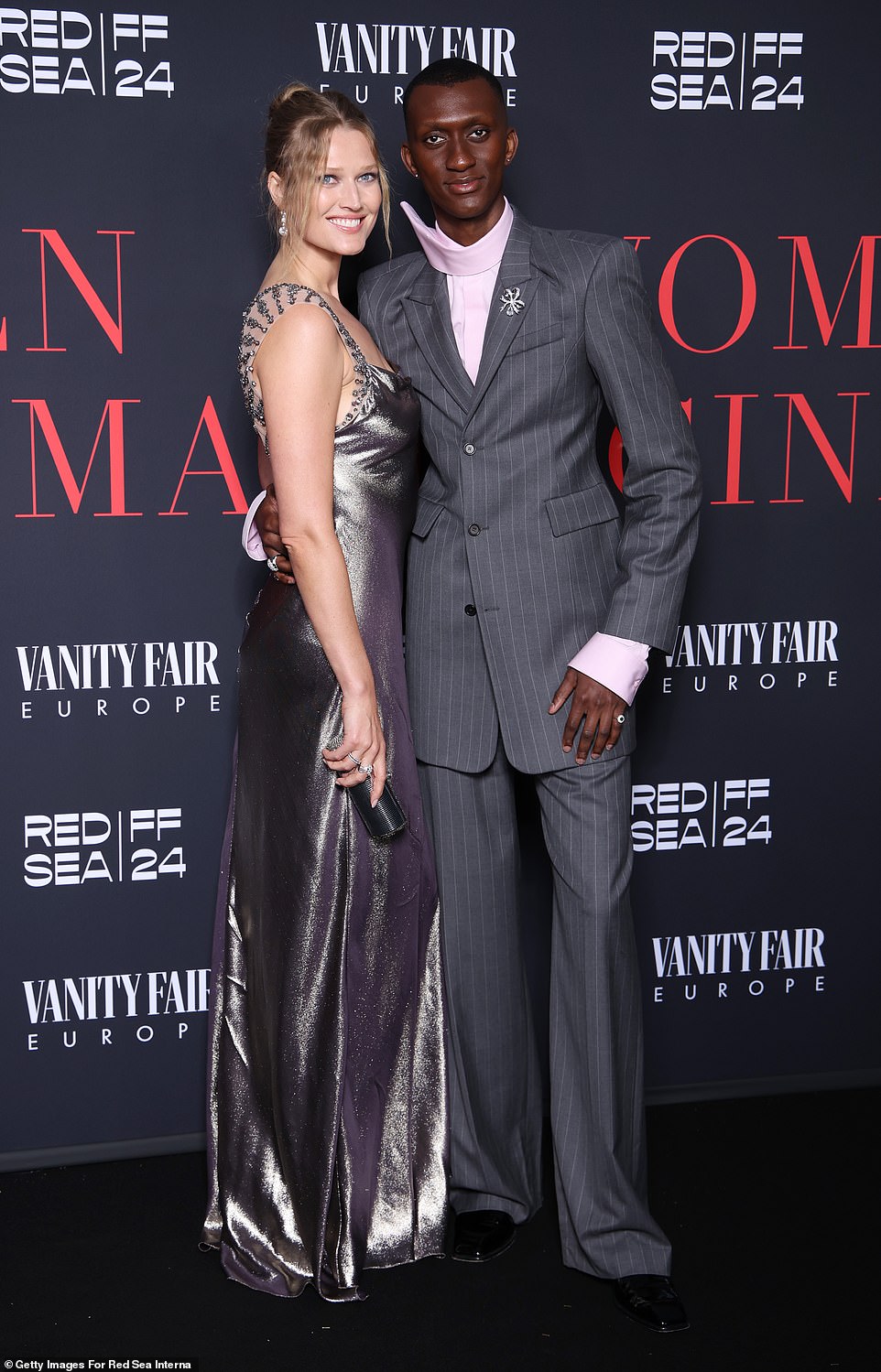 Toni Garrn, 31, and Alioune Badara, 34, were a stylish pair as they modeled complementing, pale purple outfits. The Senegalese footballer wore a gray, pinstriped blazer with matching trousers, which he paired with a light purple button-down with a dramatic swoop collar