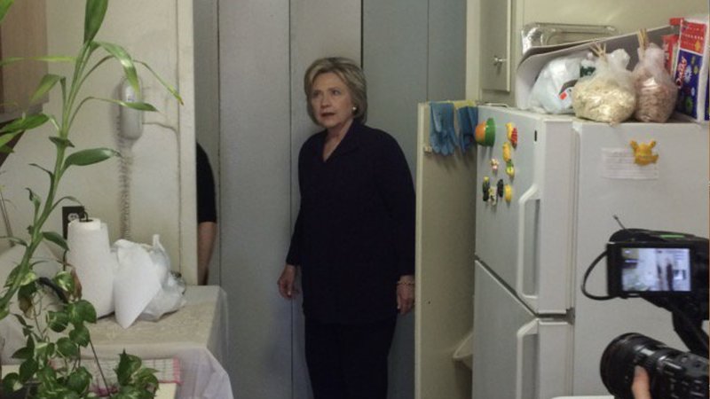 hillary clinton looking confused in a working class kitchen
