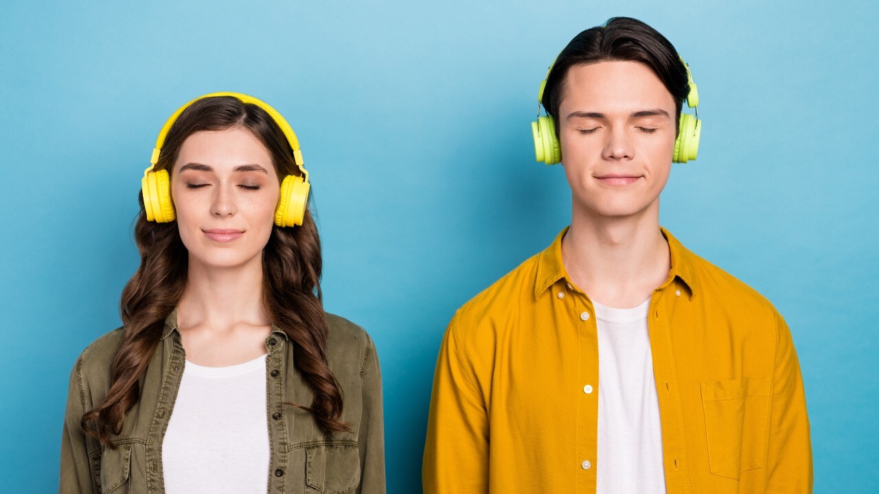 two people listening to headphones with their eyes closed