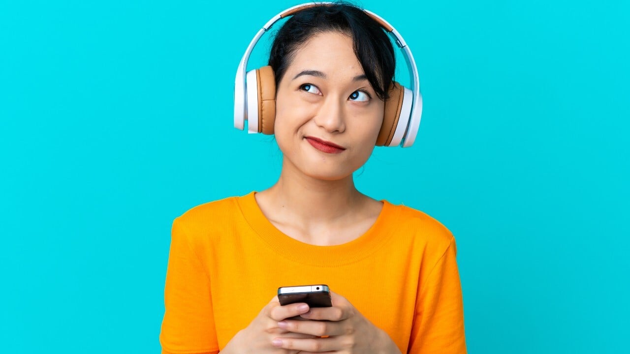 woman listening to music on her phone through headphones