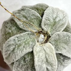 a close up of a stuffed animal with a flower on it's back end