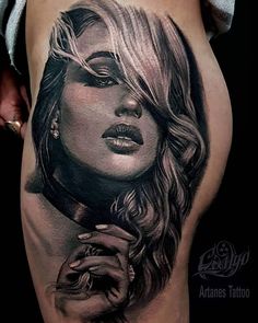 a woman's thigh with a tattoo on it