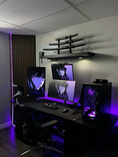 two computer monitors sitting on top of a desk in front of a wall mounted tv