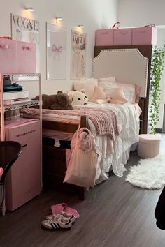 a bedroom with pink furniture and accessories on the floor