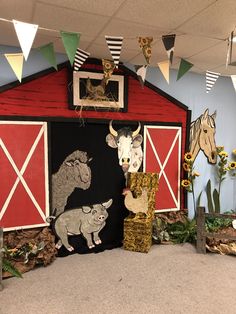 an animal themed display in a room with decorations on the wall and cow, pig, horse, and barn