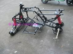 the front end of a motorcycle is shown with its suspensions and springs attached to it