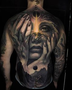 a man with tattoos on his back covered in artwork