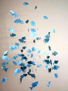 some blue paper birds are flying in the air and there is no image on it