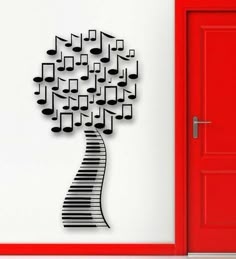 a piano tree with musical notes on it and a red door in front of it