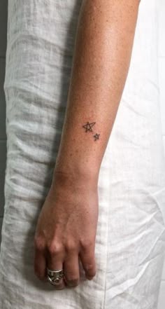 a person with a small star tattoo on their arm