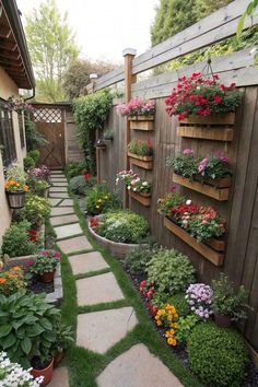 an outdoor garden with flowers and plants growing on the side of it's fence