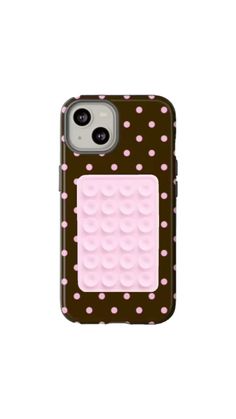 an iphone case with pink and brown dots on the front, and a lego block in the back