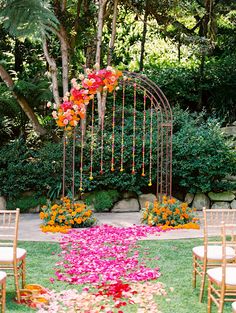 an outdoor ceremony setup with chairs and flowers