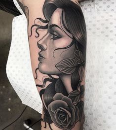 a woman's face with roses and leaves on her arm