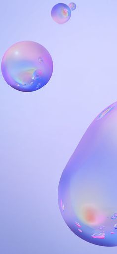 three soap bubbles floating in the air