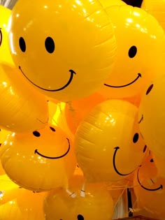 many yellow balloons with smiley faces on them