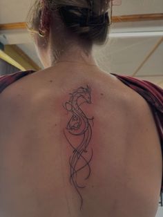 a woman with a dragon tattoo on her back
