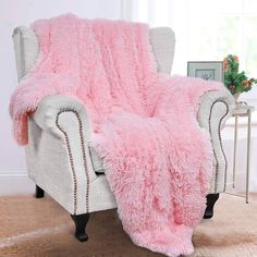 a chair with a pink fluffy blanket on it