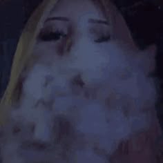 a blurry image of a woman with her eyes closed