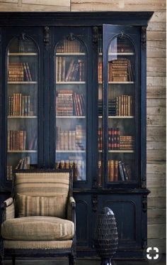 an antique french bookcase with books in it
