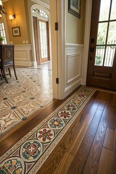 an entryway with wooden floors and tile designs on the flooring in front of it