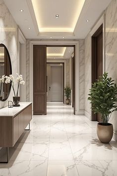an elegant bathroom with marble floors and walls, along with potted plants on the counter
