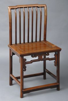 an old wooden chair with two small chairs on it's back legs and arms