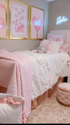 a bedroom with pink and white decor on the walls