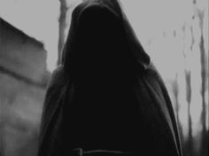 black and white photograph of a person wearing a hooded jacket