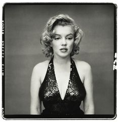 a black and white photo of a woman wearing a halter top with sequins on it