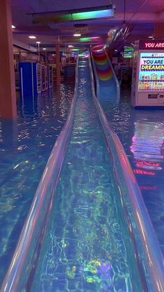an empty water slide is in the middle of a mall floor that looks like it's going down