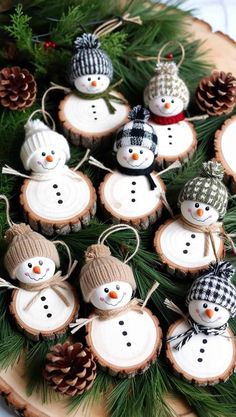 christmas ornaments made from wood slices and pine cones on a platter with pine cones