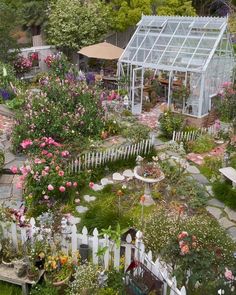 Colorful Garden with Picket Fence and Greenhouse