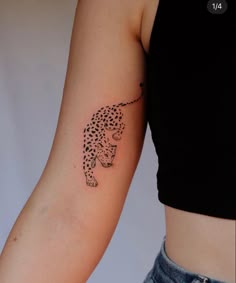 a woman with a cheetah tattoo on her arm