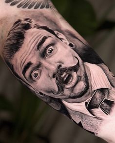 a man with a beard and mustache on his arm