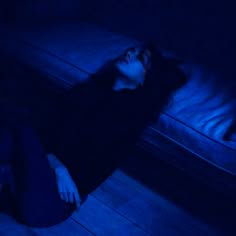 a woman is laying on the floor with her eyes closed