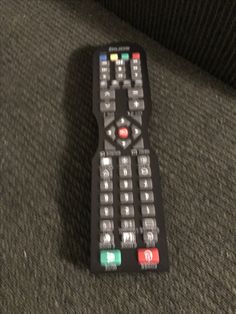 a remote control sitting on top of a couch