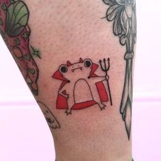 a small tattoo on the leg of a person with an animal and fork in it