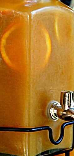 an orange juice dispenser is shown in this image