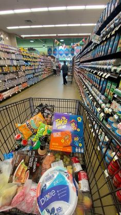 a shopping cart filled with food in a grocery store